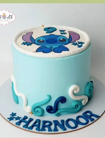 A cute and simple Stitch-themed cake. This light blue cake features the adorable alien and wave-like decorations, perfect for a fan of Lilo & Stitch.