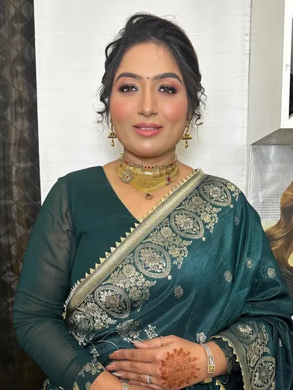 A beautiful, simple party look. The focus is on her glowing skin and a soft, elegant eye makeup that enhances her natural features.