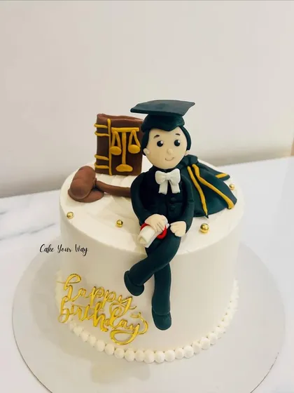 Justice is served with cake. A special graduation cake for a future lawyer, complete with a fondant figure, gavel, and law books.