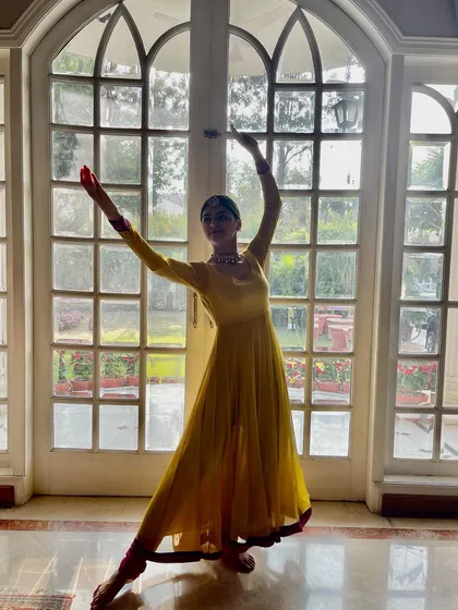 A full-length pose from the 'Tere Bin' shoot, showcasing the graceful lines of Kathak against a beautiful architectural backdrop.