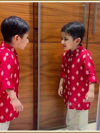Another mirror shot of our little client admiring his festive red kurta. It’s a look that’s sure to bring a smile to his face.