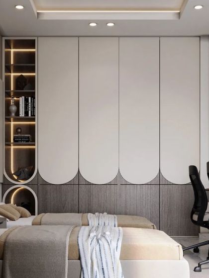 A shared bedroom for two with custom beds and a dual-station study desk. The scalloped wardrobe doors and integrated lighting add a touch of modern elegance.