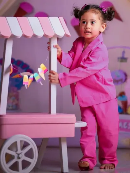 A toddler takes charge of the candy cart in a stylish pink suit. We can adapt themes for different ages and personalities.