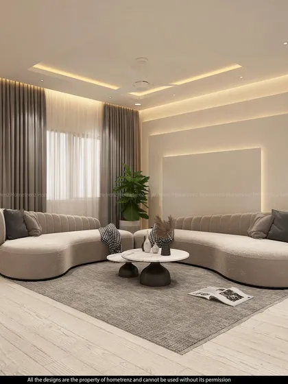 This living room features two unique curved sofas that encourage conversation. The soft, neutral tones and ambient cove lighting create a serene and elegant atmosphere.