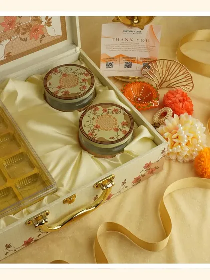 Embrace the purity of white for Navratri. This elegant floral suitcase box is perfect for gifting sweets and dry fruits as you transition into the Diwali season.
