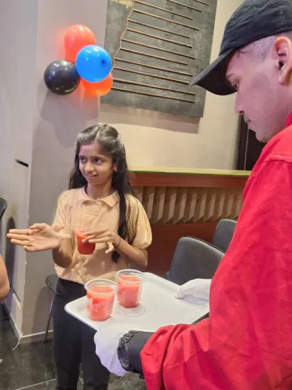 Our staff serving refreshing watermelon juice to young guests at a birthday party. We always have kid-friendly options on the menu.