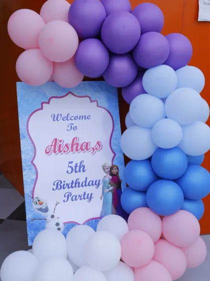 A beautiful welcome sign for Aisha's 5th 'Frozen' birthday party. The color palette of purple, blue, and white perfectly captures the movie's aesthetic.