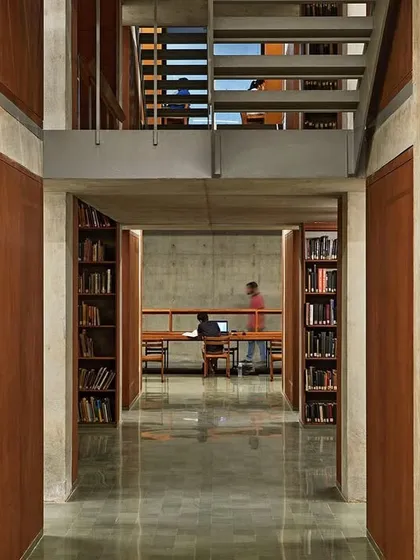 A view through the stacked levels of the Lilavati Lalbhai Library. The design creates a series of interconnected spaces, allowing for visual transparency between different library sections while maintaining distinct zones for study.