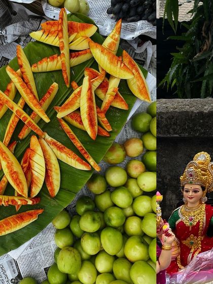 A vibrant street stall with sliced guava, green jujubes, and a small idol of Goddess Lakshmi.