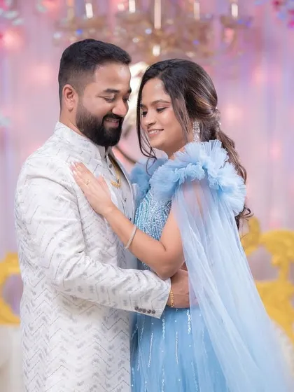A beautiful portrait of the couple against a stunning floral backdrop. The bride's soft glam makeup and romantic hairstyle complete the look.