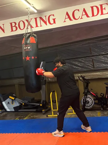 A student works on his right cross, putting his full body into the punch. The heavy bag is the perfect tool for safely practicing and developing knockout power.
