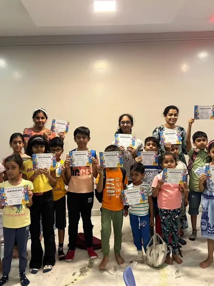 A group photo of our summer camp graduates, all proudly displaying their certificates of completion.