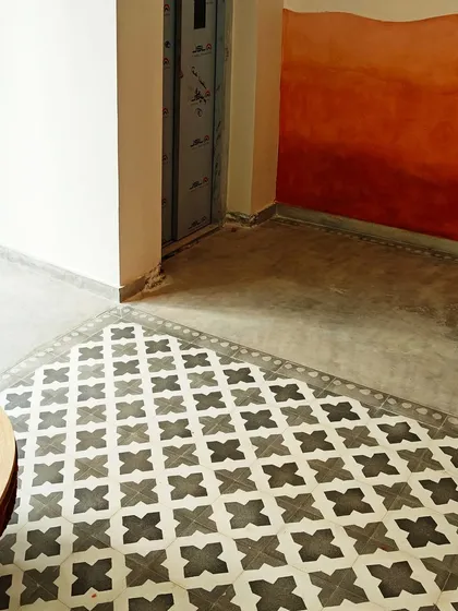 A work-in-progress shot from Villa 17. Here you can see the custom-printed cement tiles being laid next to a wall mural, designed to flow together seamlessly.