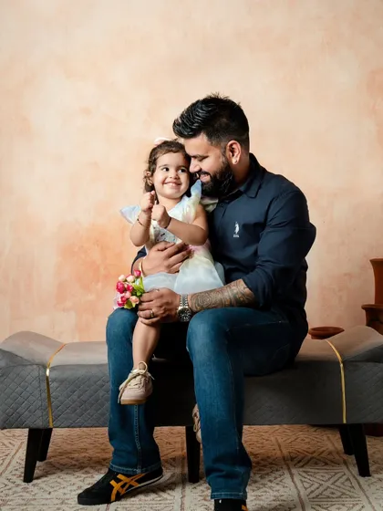 A father's gentle smile says it all. I focus on capturing these subtle interactions that highlight the unique bond each parent shares with their child during our family photography sessions.
