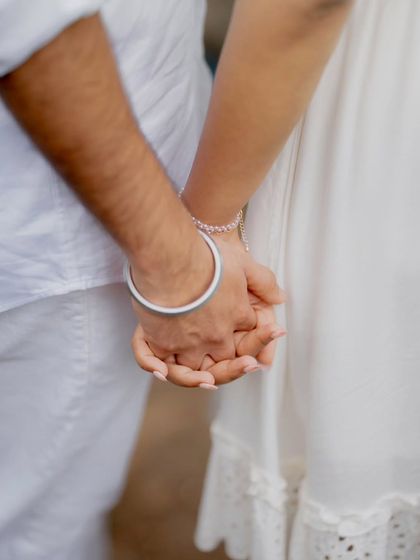 A close-up shot of the couple holding hands, a simple yet powerful symbol of their connection and the journey they are on together.