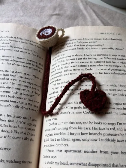 For my fellow bookworms, a handmade crochet bookmark designed to look like a tiny cup of coffee with a heart charm.