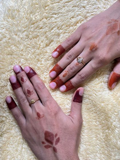A comparison of a fresh henna stain and a mature, dark stain, using simple leaf motifs.