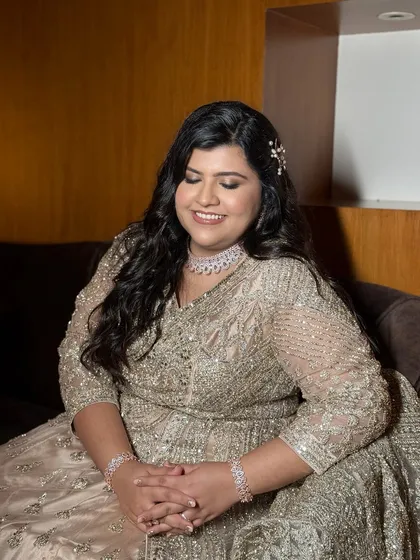 A serene, smiling portrait. The makeup is designed to enhance her natural beauty and celebrate who she is.