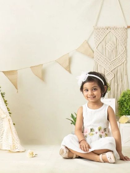 My boho-themed sessions use natural textures like macrame, wood, and greenery to create a calm and earthy setting that beautifully complements your child's simple joy.