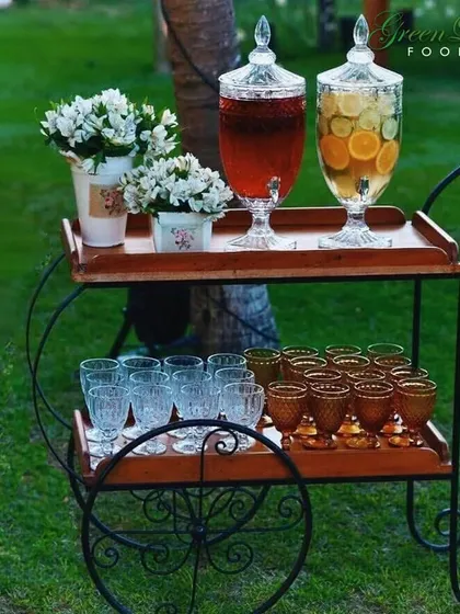 Our beverage cart is a charming addition to any outdoor party. It comes stocked with beautiful glassware and dispensers of colorful, fresh juices, creating an inviting and stylish drink station.