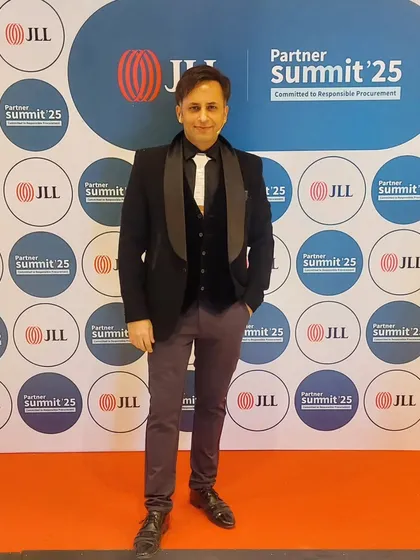 Posing at the JLL Partner Summit. The branding and event setup were top-notch, providing a great backdrop for my performance.
