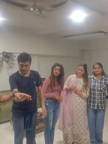 A group of our adult students engaged in a theatre game. These exercises are designed to break inhibitions and build trust among the actors.