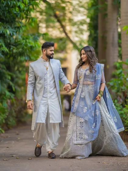 A classic walking shot of Saurabh and Aishwarya holding hands. This captures the beginning of their journey together in a candid and elegant way.