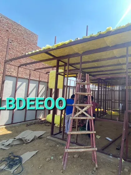 Work in progress on a G+1 prefabricated building in Meerut. The images show the MS frame being erected and glass wool insulation being installed in the roof.