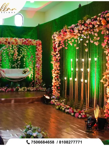 A beautiful photo booth setup with a floral swing. The backdrop of hanging candles and flowers creates a romantic and whimsical spot for pictures.