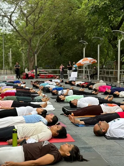 A moment of collective rest in Savasana during our outdoor International Yoga Day event. Even in a large group, finding stillness together is a powerful and unifying experience.