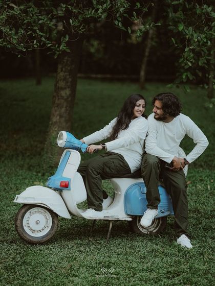 The couple sharing a sweet moment on a vintage scooter, a fun and nostalgic prop for a pre-wedding shoot.
