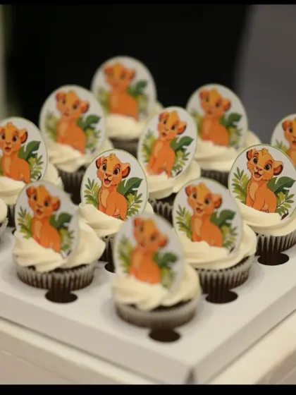 Here are the matching Simba themed cupcakes that went with the main cake. Each one is topped with an edible image of Simba, creating a cohesive look for the dessert table.