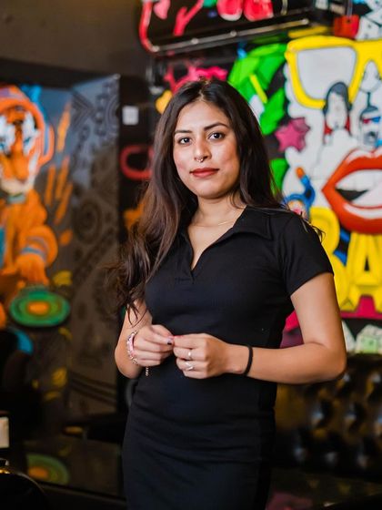 A guest posing against the graffiti wall.