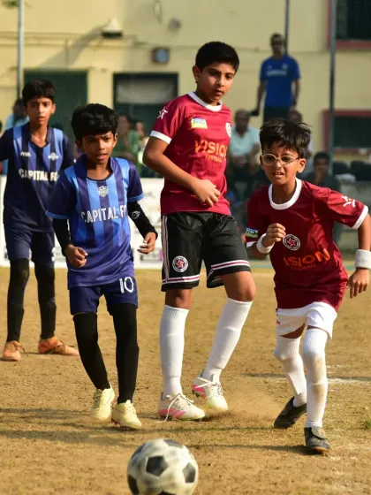 A young player charges forward with the ball, demonstrating the attacking intent we encourage in our teams.