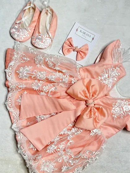 Another view of our peach lace newborn dress set. The large bow on the dress adds a beautiful finishing touch.