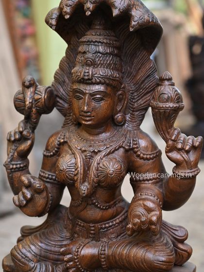 A powerful 26-inch sculpture of the goddess Naga Rani, the serpent queen. The five-headed cobra forms a protective canopy over her, symbolizing her command over mystical energies.