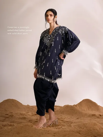 The navy Orion Kaftan Set, a stunningly embellished kaftan paired with solid dhoti pants, perfect for an evening of celebration.