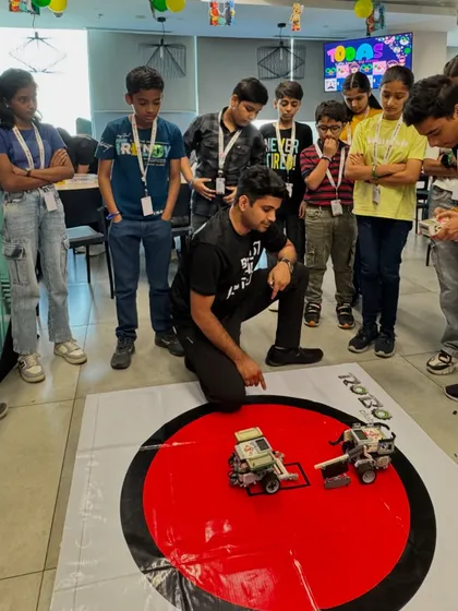 The energy was electric at the MetLife GOSC corporate event. This shot captures the final moments of a Sumo Bots challenge, where older kids gathered to watch the robots they built and coded battle for supremacy. Our corporate workshops are a fantastic way to engage families and promote team building.