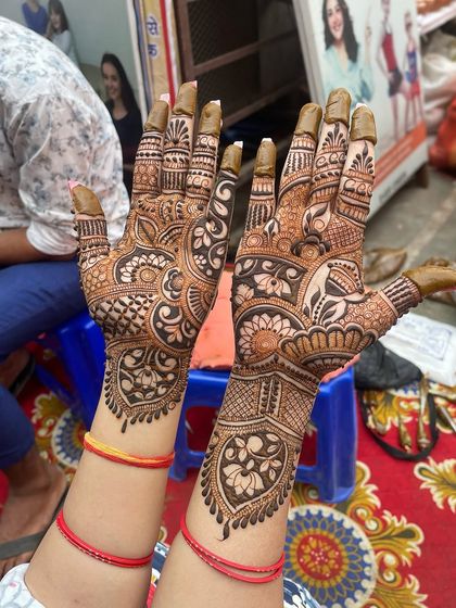 A beautiful example of a full bridal mehandi with a mix of everything: peacocks, lotuses, hearts, and intricate filler patterns.