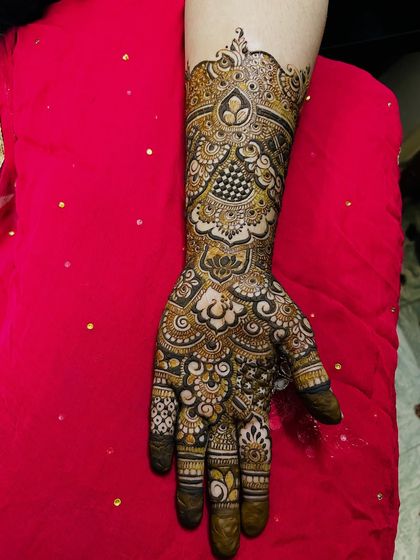 Another view of this fusion design, showing the intricate patterns on the fingers and the bold motifs on the back of the hand.