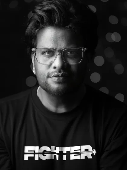 A strong, black and white portrait for a male model. The 'Fighter' t-shirt and direct gaze create a powerful and confident look.