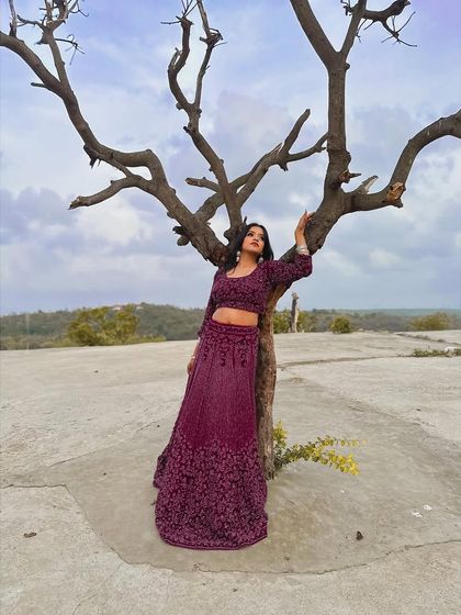 The full view of this wine-coloured lehenga showcases its elegant A-line skirt and contemporary crop top. It’s a perfect example of understated glamour available for rent.