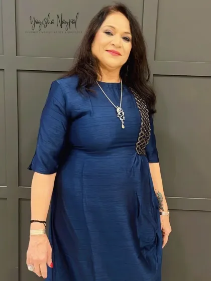 A timeless and beautiful look for a client in a blue dress. The makeup is elegant and enhances her mature skin with a radiant glow.