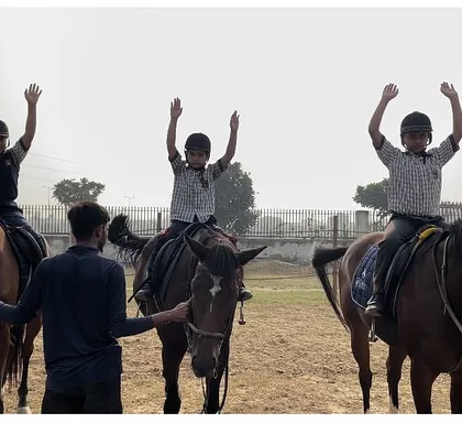 Young riders learning balance and confidence under the watchful eye of our instructor. We focus on building foundational skills in a safe and encouraging environment for kids.