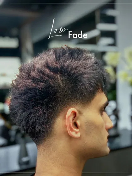 A subtle yet stylish low fade. This cut keeps more length on the sides while still providing a clean, tapered finish around the ears and neckline.