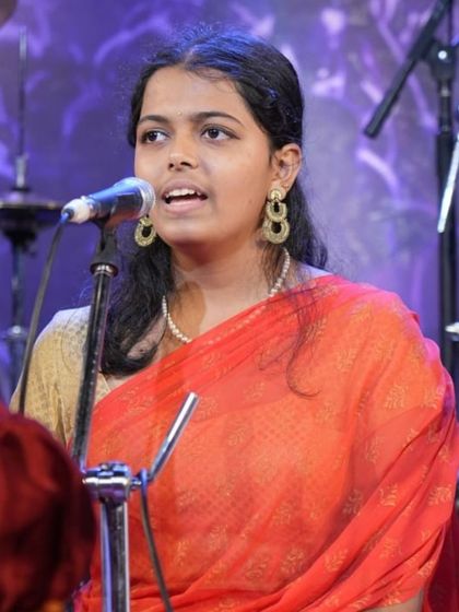 A senior student leads a section of the Carnatic vocal rendition with grace and confidence.