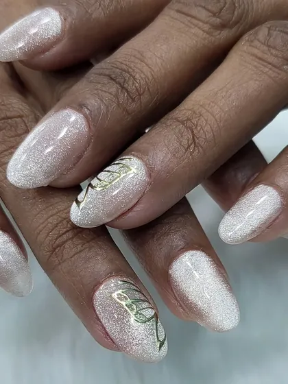 A delicate and ethereal design. This look features a shimmery white glitter base with a simple, elegant butterfly outline hand-painted in gold.