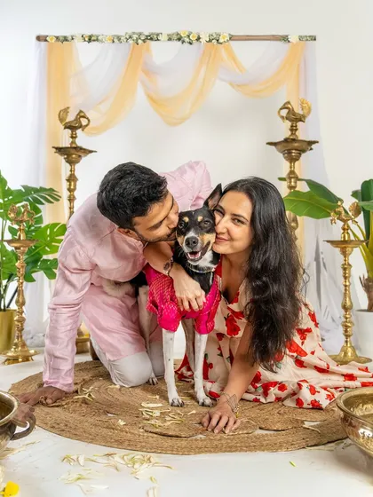 A couple shares a loving moment with their dog during a Diwali mini-session. The festive outfits and happy expressions make this a perfect holiday memory.