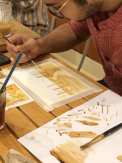 A close-up of a participant learning the brushstrokes for coffee painting. I guide everyone through the basics to build their confidence.