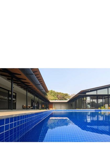 The long, linear pool at Villa 15 reflects the sky and the simple, one-room-thick structures. The pool also acts as a passive cooling device for the home.